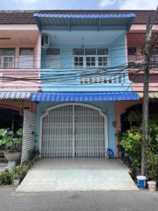 a blue house with a white garage door at Blue House Hat Yai in Hat Yai