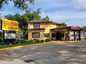 a building with a sign for a taco star lodge at Twin Star Lodge in Biloxi