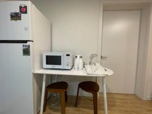 a white table with two chairs and a microwave at NamSan Pearl Stay in Seoul +57 photos