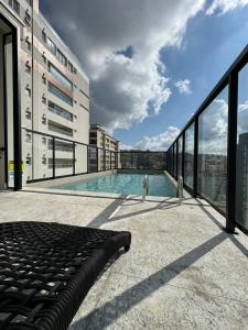 a balcony with a swimming pool on top of a building at Studio Aconchegante in Poços de Caldas