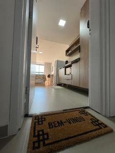 a hallway with a rug on the floor in a house at Studio Aconchegante in Poços de Caldas