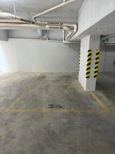 an empty parking lot in a parking garage at Studio Aconchegante in Poços de Caldas