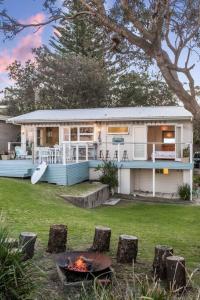 a house with a fire in front of it at The Mook on Mollymook Beach in Mollymook