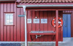 a red building with a sink and a life preserver at Holiday Home Risør 55 in Songe