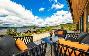 a patio with couches and a table on a balcony at 4 Bedroom Nice Home In Sannidal in Sannidal +19 photos