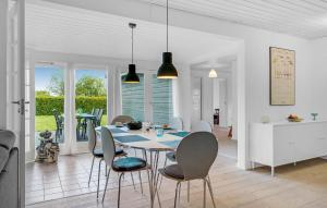 a kitchen and dining room with a table and chairs at 4 Bedroom Nice Home In Slagelse in Slagelse