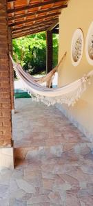 a hammock hanging from the side of a building at Casa da Gio Penedo in Penedo +13 photos