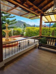 a porch with a fountain and a bench on a balcony at Chalet D'Elena in Nobsa