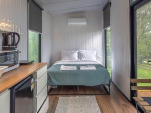 a small bedroom with a bed and a window at The Fog Getaway by Tiny Away in Boolambayte