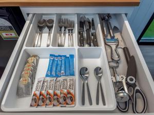 a drawer filled with lots of utensils at The Fog Getaway by Tiny Away in Boolambayte