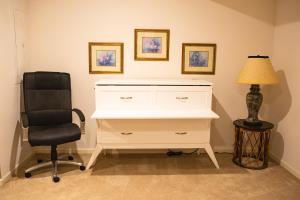 a desk with a chair and a lamp in a room at Beautiful Parkside Suite in Saint James +41 photos