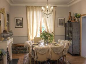 a dining room with a table and chairs and a chandelier at Maison de Charme avec Terrasse et Animaux Acceptés à Moulins - FR-1-489-532 in Moulins