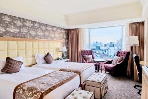 a hotel room with two beds and a window at InterContinental Tokyo Bay by IHG in Tokyo
