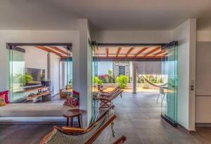an open living room with glass doors and chairs at BRISAS 5 CASA de playa ENTRE VALLARTA Y SAYULITA in Nuevo Vallarta 
