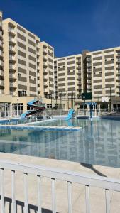 a large swimming pool in front of a large building at Apto 5 Estrelas no Centro de Pelotas in Pelotas