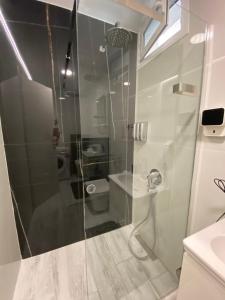 a shower with a glass door in a bathroom at Astradeni Suite in Nea Potidaea +41 photos