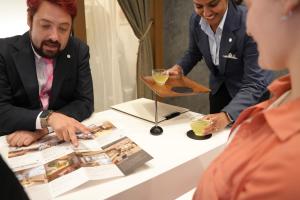 two men and a woman looking at a table with drinks at Birupaku in Shizuoka