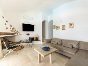 a living room with a couch and a table at Luxe Côte Stay- Elegant Villa in Porto Cervo