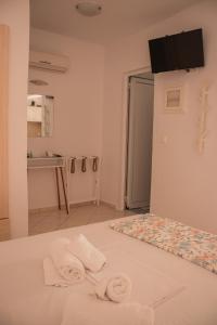 a room with a bed with towels on it at Villa Sissy Studios & Apartments in Syvota +205 photos