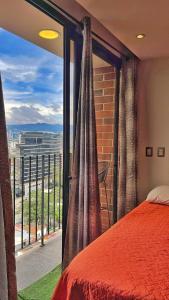 a bedroom with a large window with a view at Airali 1 - Apartamento en el centro - Zona 10 de la Ciudad de Guatemala in Guatemala +17 photos