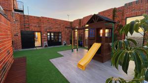 a playground in a brick building with a slide at Airali 1 - Apartamento en el centro - Zona 10 de la Ciudad de Guatemala in Guatemala