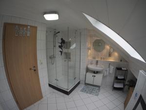 a bathroom with a shower and a sink at Ferienhaus Gerda in Osteel +30 photos