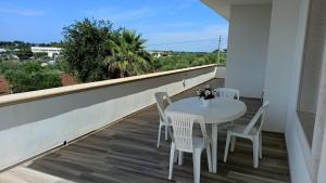 a white table and chairs on a balcony with a view at Villa Perla Bianca - Terrazza Panoramica - by Gessica Holiday in Polignano a Mare