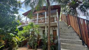 a staircase leading up to a house with palm trees at Drift in Arugam Bay