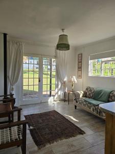 a living room with a couch and a table at charming guest house in Twee Riviere