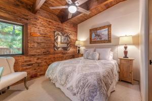 a bedroom with a bed and a chair and a window at Tahoe City 4BR 4 Full Bathroom Home Near Palisades Close to Town in Tahoe City