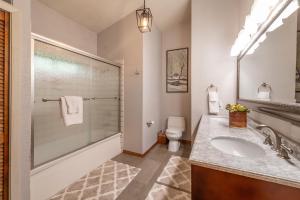 a bathroom with a shower and a sink and a toilet at Tahoe City 4BR 4 Full Bathroom Home Near Palisades Close to Town in Tahoe City +52 photos