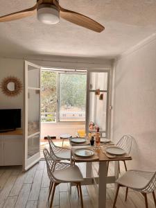 ein Esszimmer mit Tisch und Stühlen und einem Fenster in der Unterkunft Miramar By Bellavista - 250 m de la plage - terrasse in Argelès-sur-Mer