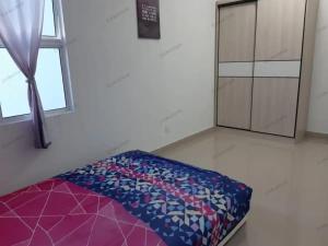 a bed in the corner of a room with a window at Erin's Homestay in Labuan