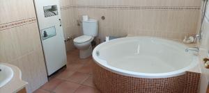 a bathroom with a tub and a toilet and a sink at Villa Oasis in Los Gallardos +43 photos