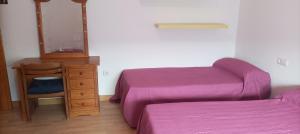 a bedroom with two beds and a dresser and a mirror at Villa Oasis in Los Gallardos