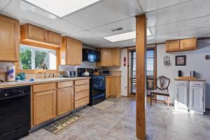 a kitchen with wooden cabinets and a sink at Hillbilly Highrise in Sevierville