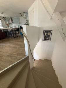 a staircase in a house with a picture on the wall at Appartement duplex cosy Saint Servan centre in Saint Malo