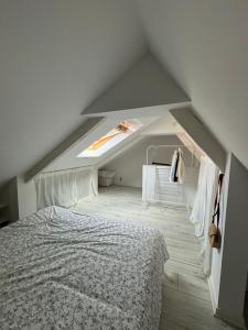 a attic bedroom with a bed and a skylight at Appartement duplex cosy Saint Servan centre in Saint Malo