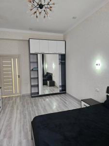 a bedroom with a large mirror on the wall at Parkentskaya 170 Tashkent apartment by RNB estate in Yalanghoch