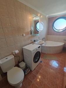 a bathroom with a toilet and a tub and a sink at Alex House Garden in Iraklitsa +51 photos