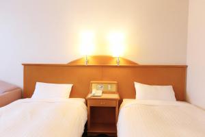 Postel nebo postele na pokoji v ubytování Hotel Castle Inn Ise Meotoiwa