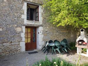 a group of green chairs sitting outside of a building at Le Logis de la Pataudière in Champigny-sur-Veude