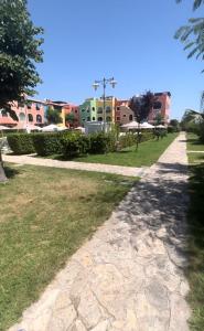 a path through a park with houses in the background at Casa Marty Borgo San Basilio in Marina di Pisticci