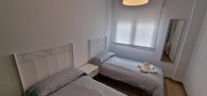 two twin beds in a room with a window at La Arena Playa San Lorenzo - Wifi - 6 pax - 3 Hab - VUT-5275-AS in Gijón