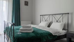 a bedroom with a bed with towels on it at Apartment in Tbilisi &ldquo;Green Budapest &ldquo; in Tbilisi City