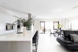 a kitchen and living room with a counter and chairs at Luxury Spacious 5 Bedroom Family Modern Villa Sleeps 10 in Waterford