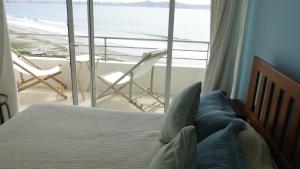 a bedroom with a bed and a view of the ocean at La Serena Departamento vista al mar in La Serena