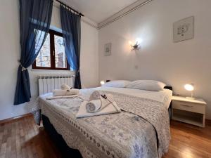 a bedroom with a bed with towels on it at APP St Marin view Novi Vinodolski in Novi Vinodolski