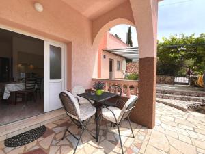 a patio with a table and chairs on a patio at APP St Marin view Novi Vinodolski in Novi Vinodolski
