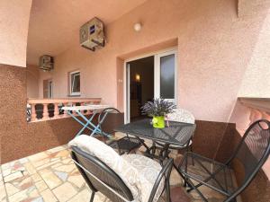 a small patio with a table and chairs and a balcony at APP St Marin view Novi Vinodolski in Novi Vinodolski +53 photos